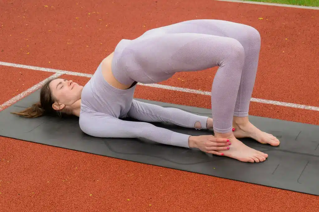 A woman practicing bridge pose.
